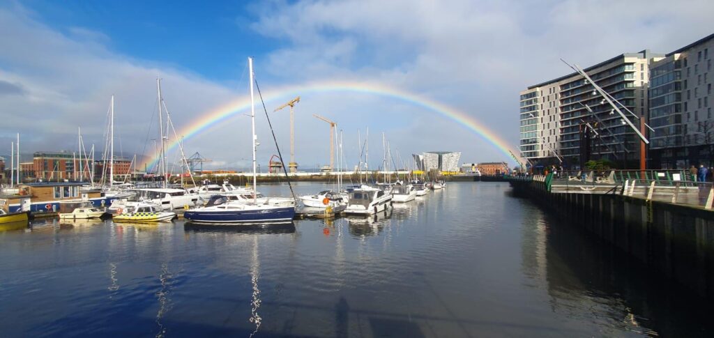 Boat on mooring under rainbow